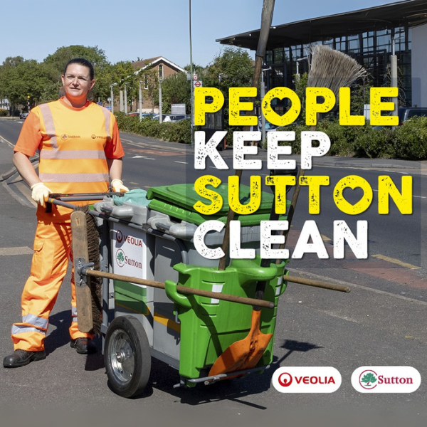 A picture of Sarah, a Veolia street cleaning worker, with her street cleaning cart outside the Phoenix Centre in Roundshaw, Sutton. The words 'People Keep Sutton Clean' over the top and the Veolia and Sutton Council logo at the bottom right.