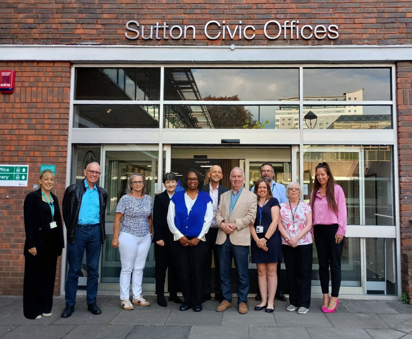 From left to right: Emma Easton, Manager of the Admiral Nursing Service; Chris Williamson; Hilary Dodd, Chief Executive of Age UK Sutton; Debbie Stinson, Consultant Psychiatrist; Sandra Howard, Director of Adult Social Care, Sutton Council; Nick Ireland, Strategic Director of People Services, Sutton Council; Councillor Barry Lewis, Leader of Sutton Council; Naomi Posterns, Adult Carers Senior Support and Development Worker; David Millen, Lead Commissioner, Sutton Council; Councillor Marian James, Lead Member for Adult Services; Michelle Blagrove, Service Manager Dementia Hub