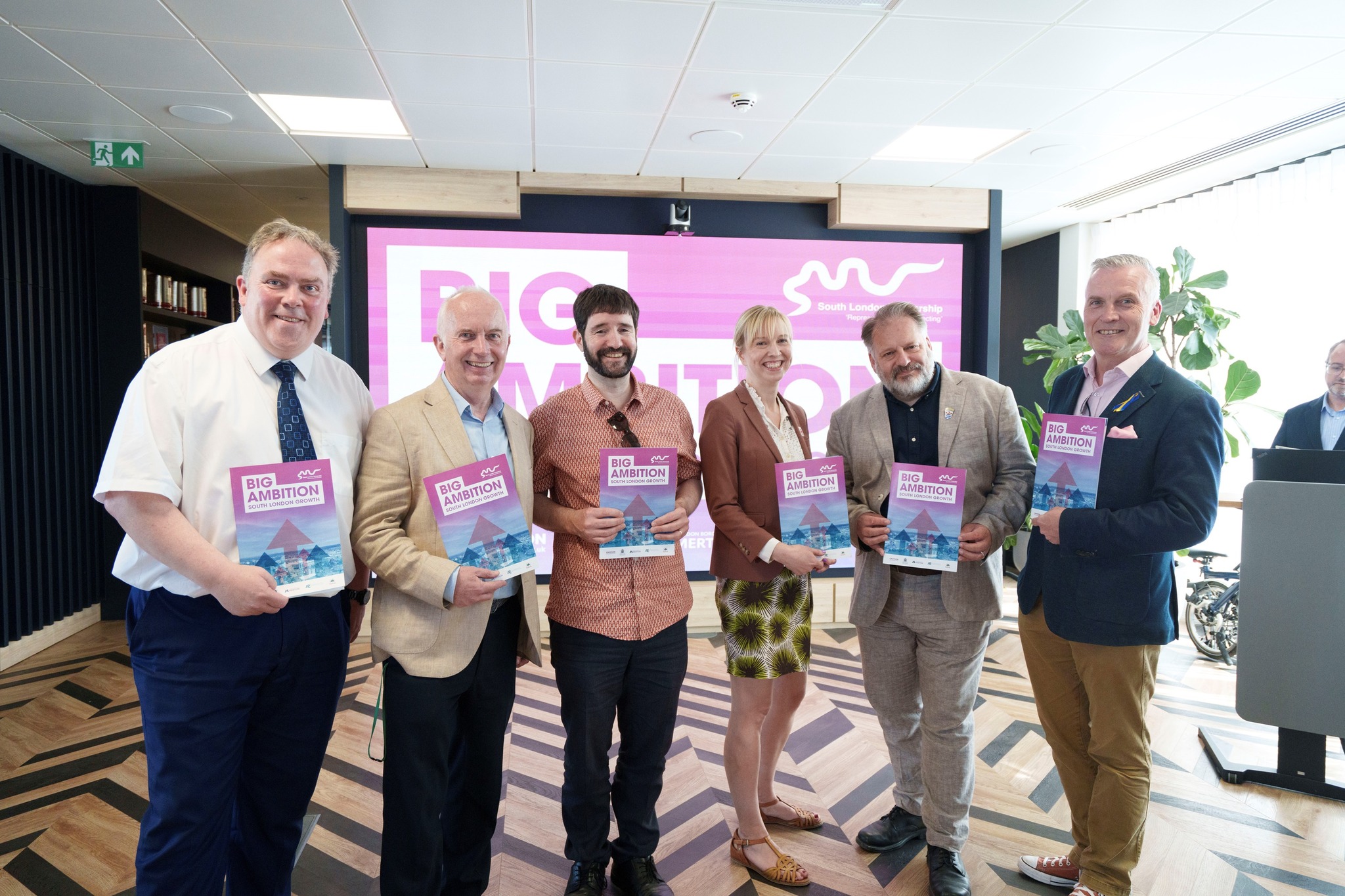 Leader of the Council, Councillor Barry Lewis at the Big Ambition South London Growth event with other people and a large banner behind