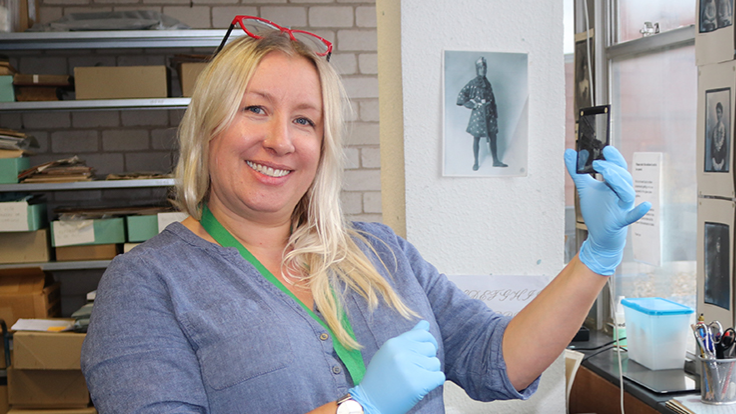 Abby Matthews of Sutton Archives working on a photographic negative
