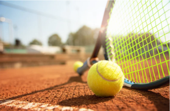 image of a tennis ball and racket on a tennis court