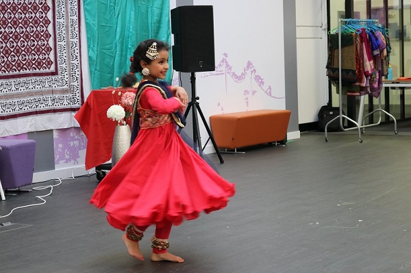 Girl dances in pink sari at Diwali event