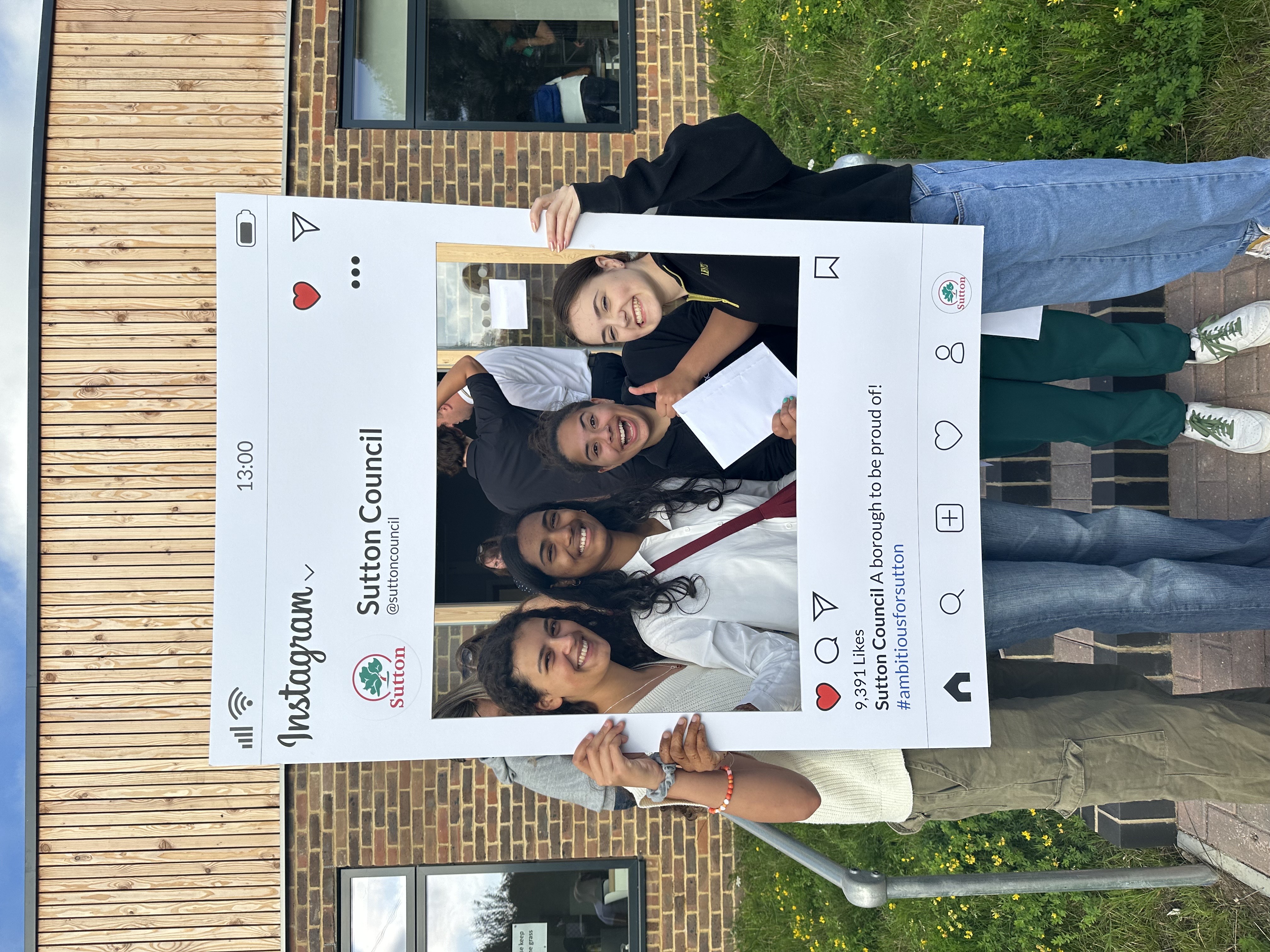 Glenthorne High School students outside holding a picture frame after receiving their A-level Results 