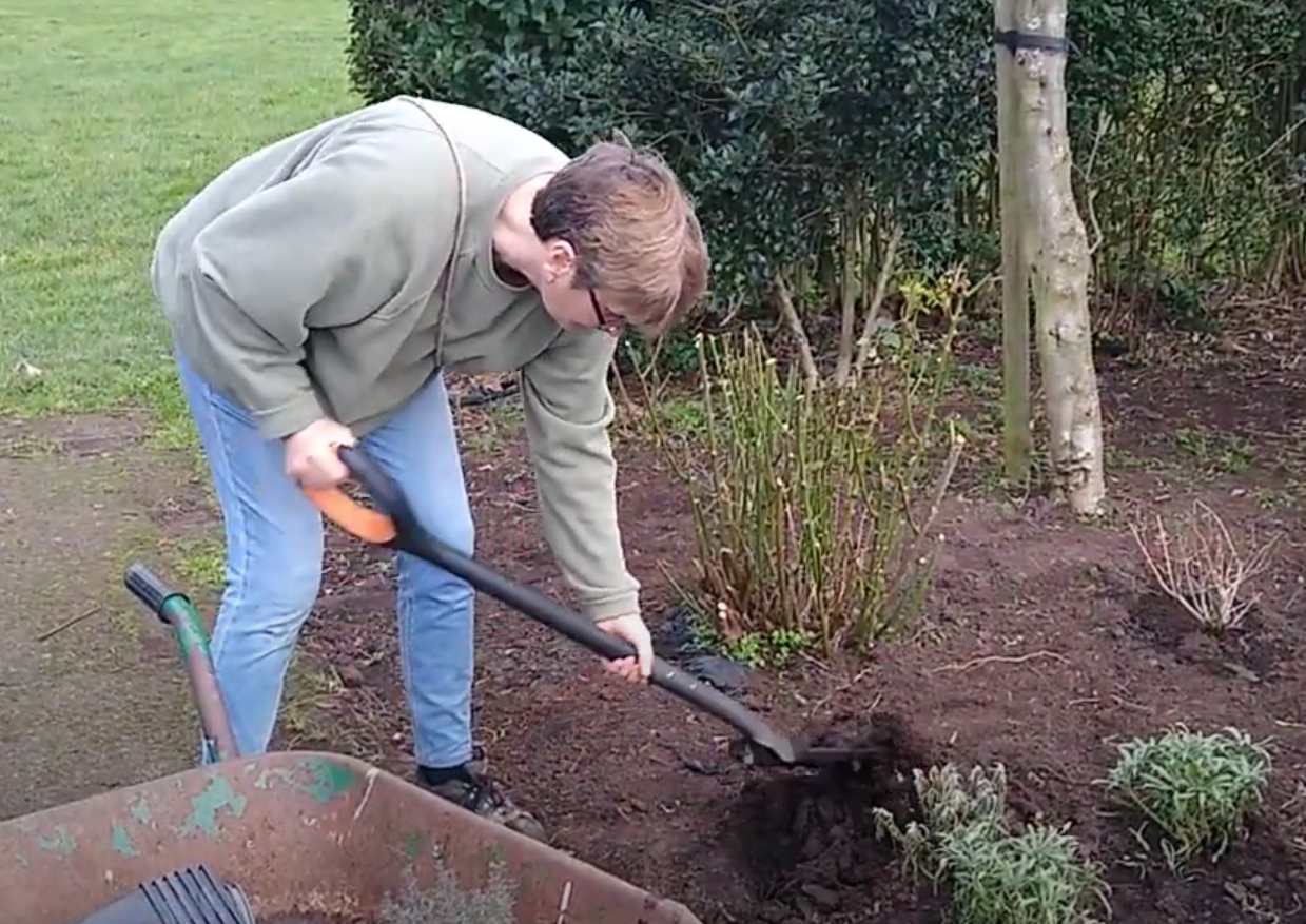 Pam digging a flower bed in Mellows Park