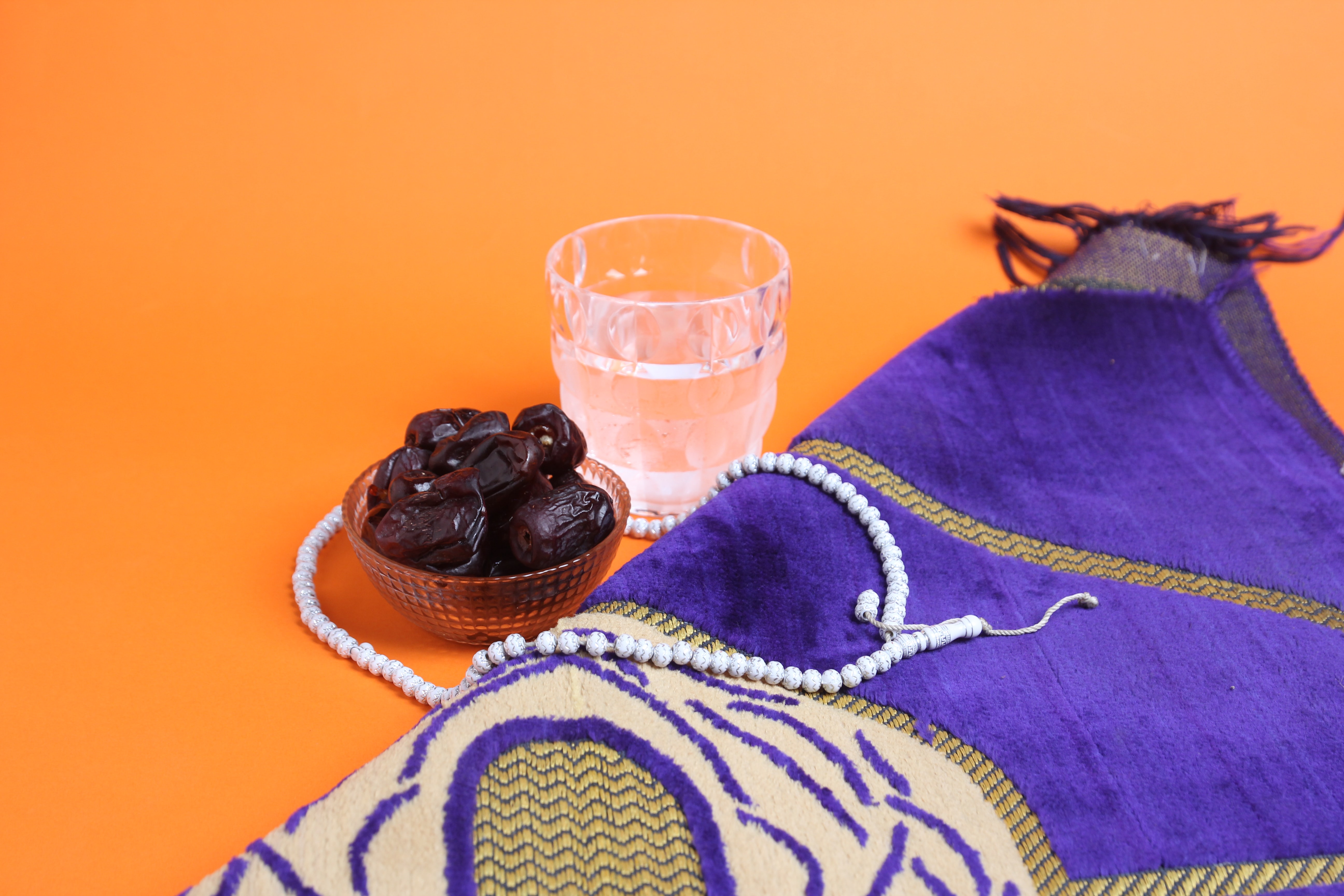 dates, glass of water, prayer beads and shawl to symbolise the holy month of Ramadan