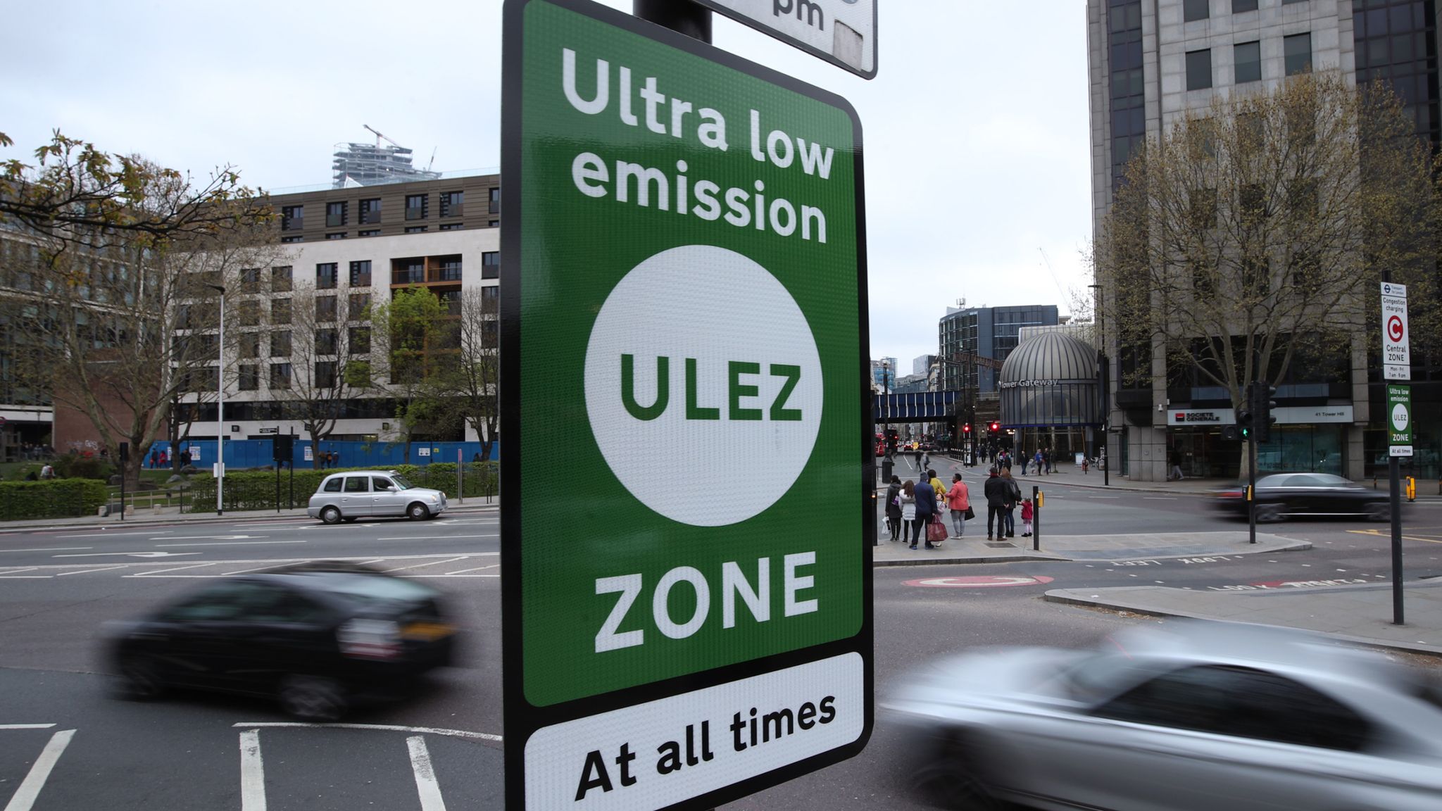 Ultra Low Emissions Zone (ULEZ) sign in London with traffic in the background