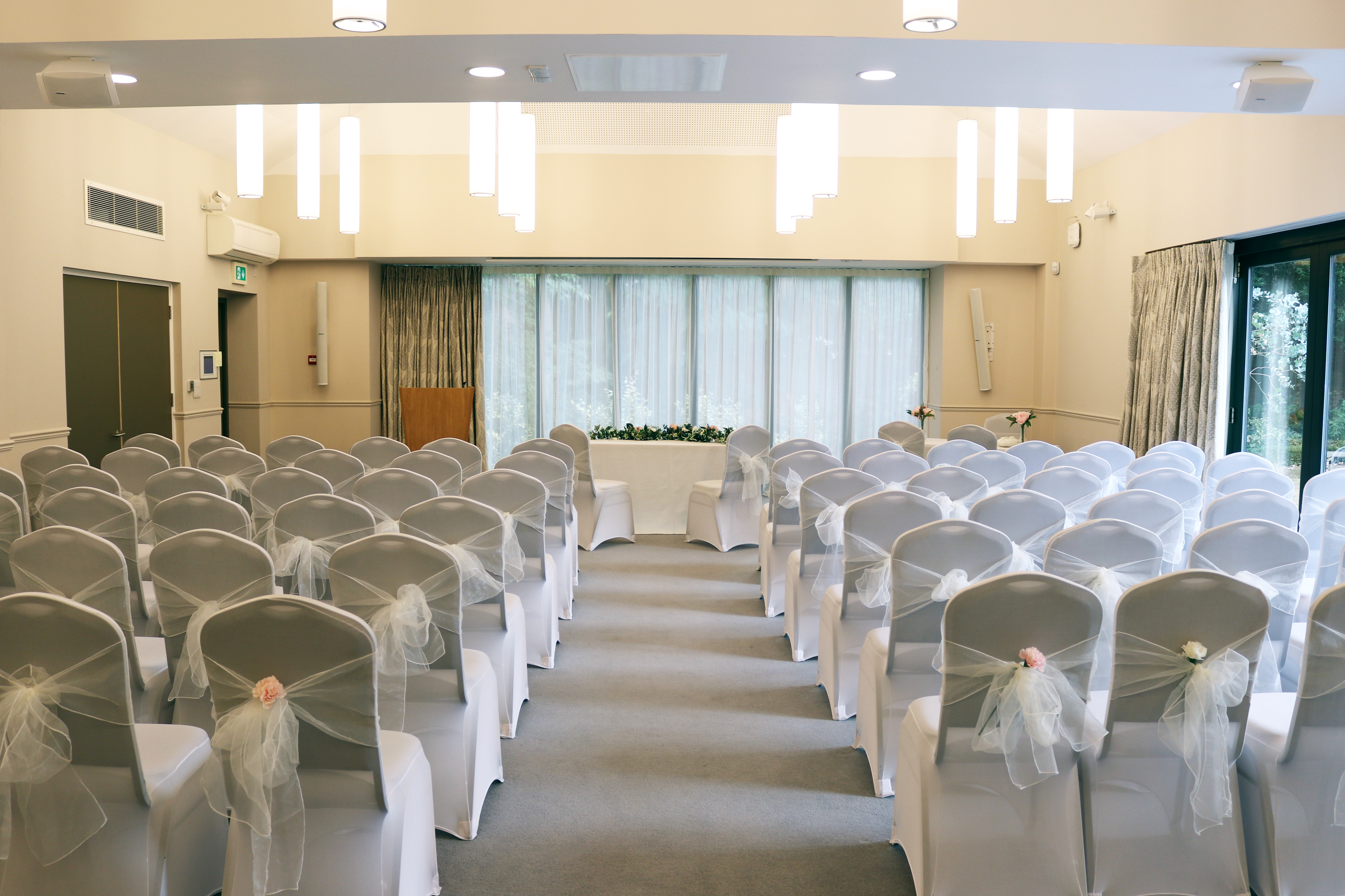 Ceremony room with rows of white chairs