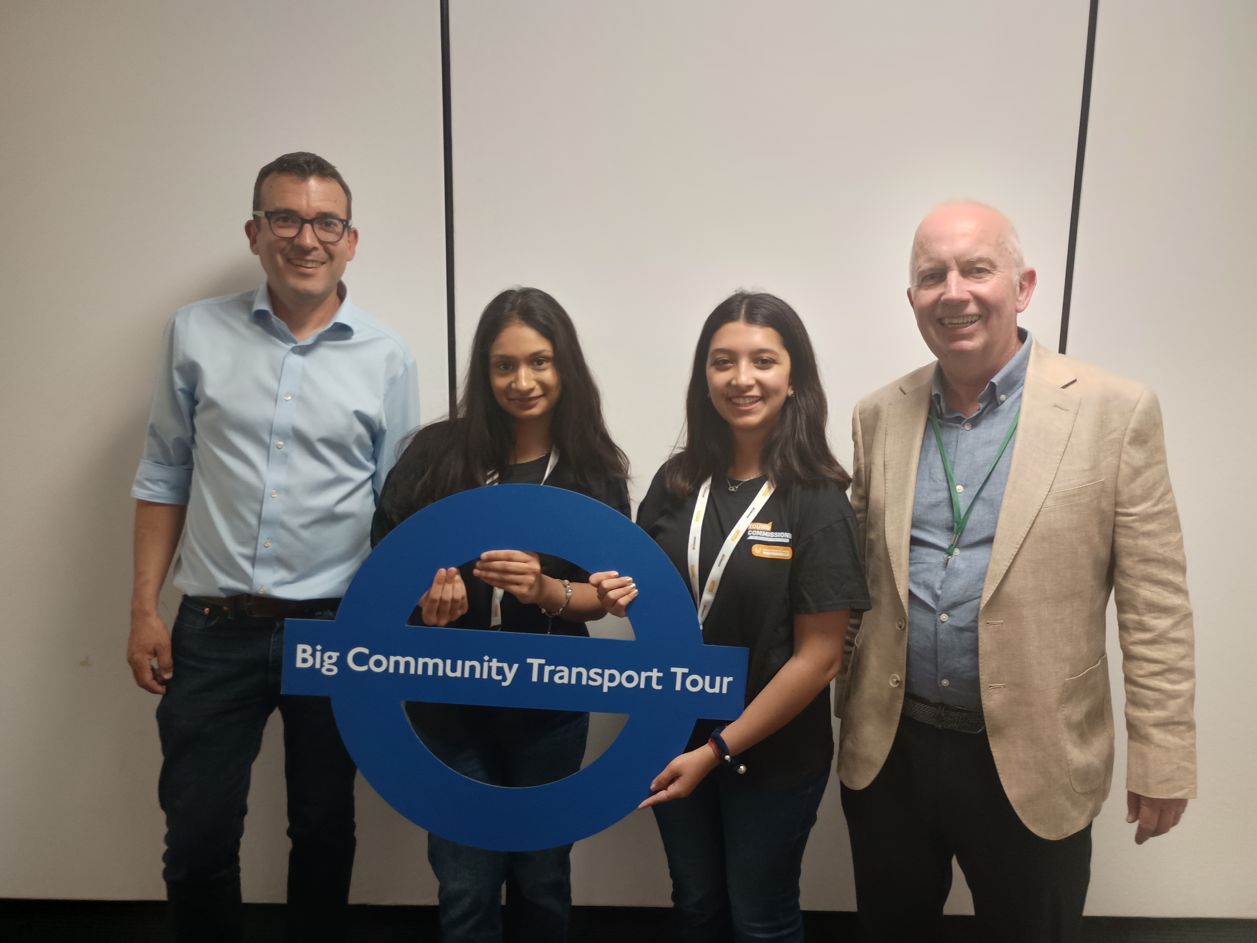 Will Norman on the left, Young Commissioners in the middle and Leader of the Council, Councillor Barry Lewis on the right with a Big Community Transport Tour sign