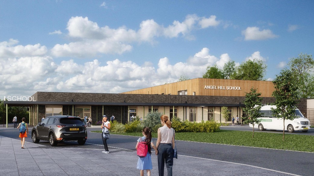 Artist impression of how the front of Angel Hill School will look. To the foreground is a young woman and a young girl in school uniform and a pink rucksack walking hand in hand towards entrance to the school, there are cars and other people. There is a white student transport van to the right of the image. The school is partically clad in wood, with the words/a sign that says Angel Hill School on the wooden cladding. 