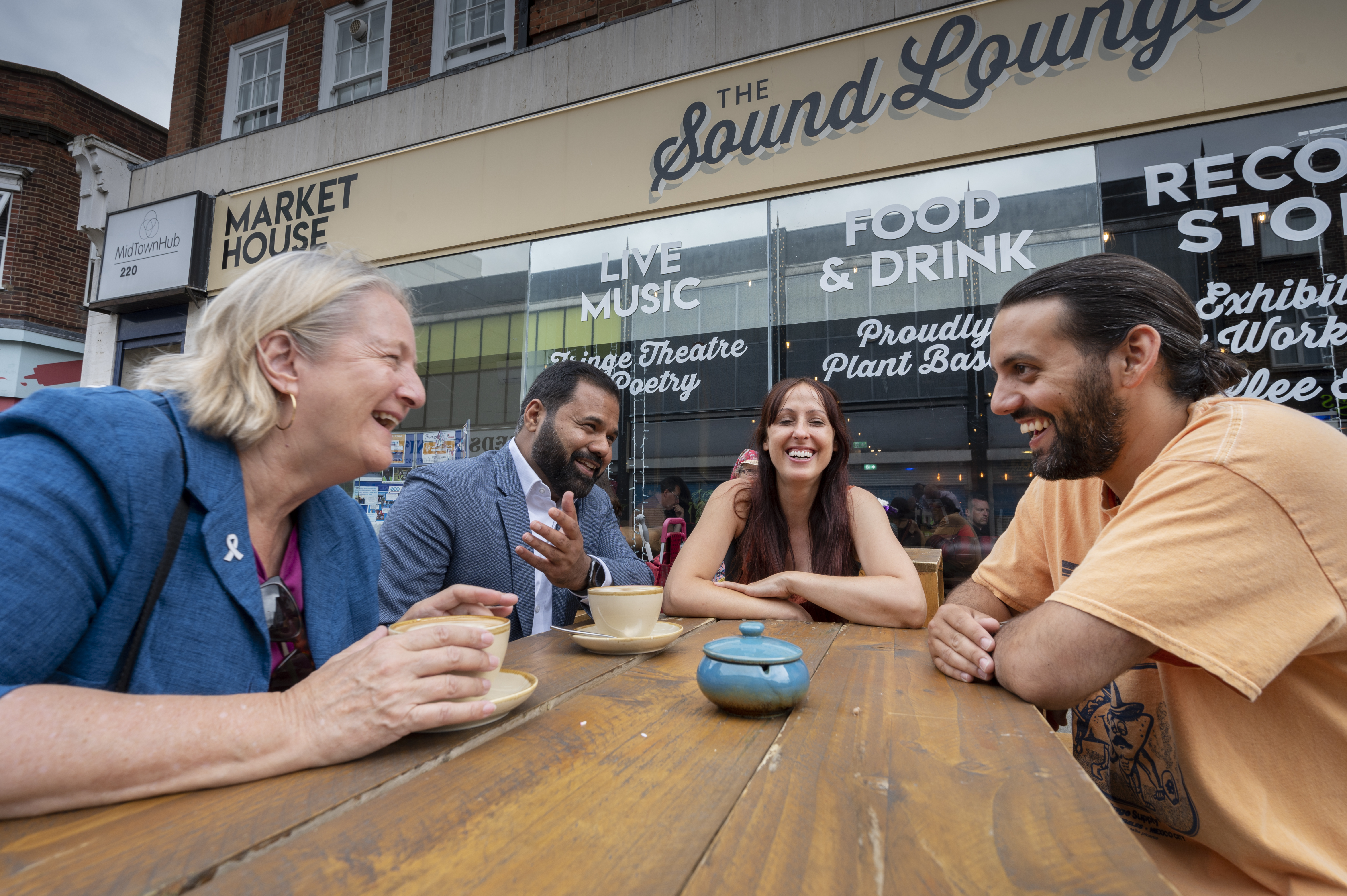 Rajesh Agrawal, Cllr Ruth Dombey, and Sound Lounge's Hannah and Kieron sitting outside the Sound Lounge