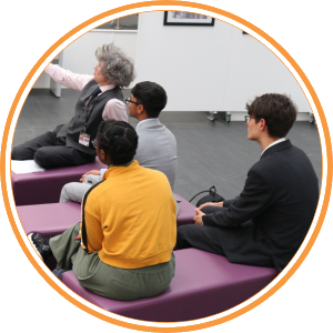 A teacher and three school children sat down