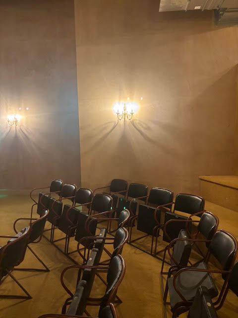 A row of black chairs in a softly lit area