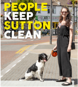 Woman sttanding next to a dog