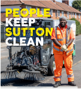 man standing next to road sweeper