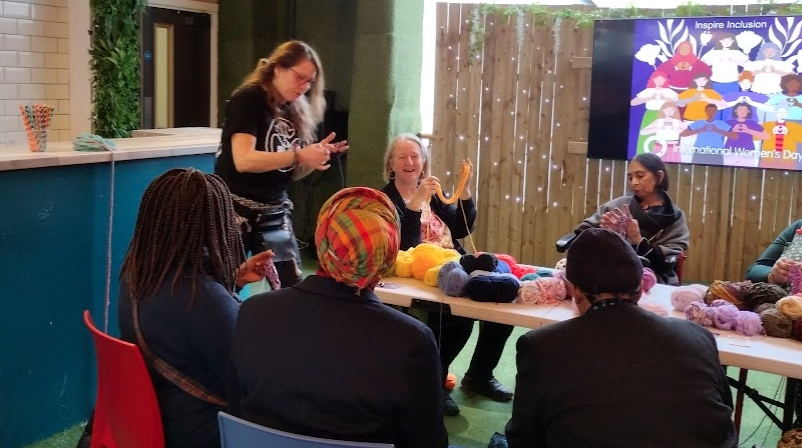 Leader of the Council, Councillor Ruth Dombey finger knitting at the International Women's Day Event at The Attic, Sutton